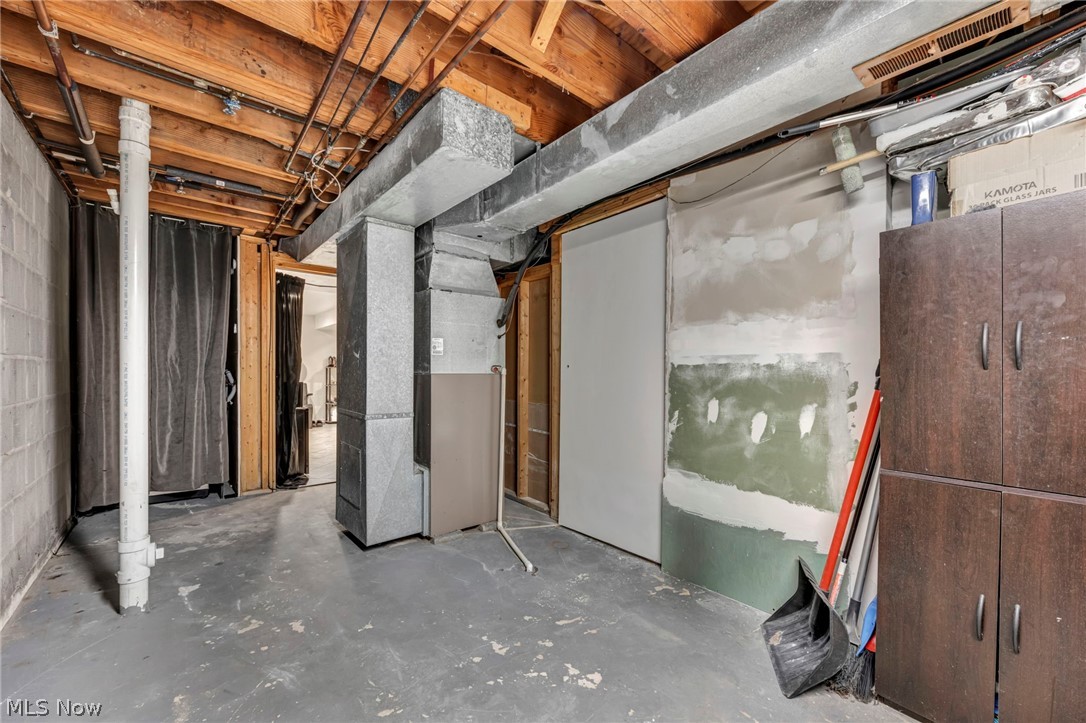 13800 Milo Road Garfield Heights, OH 44125 - Photo 27 of 39 Unfinished basement featuring heating unit