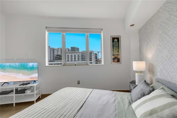 a bedroom with a bed and a flat screen tv