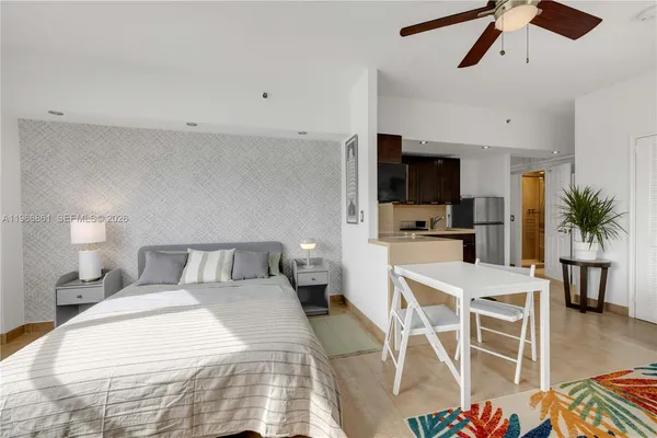 a bedroom with a bed and a flat screen tv