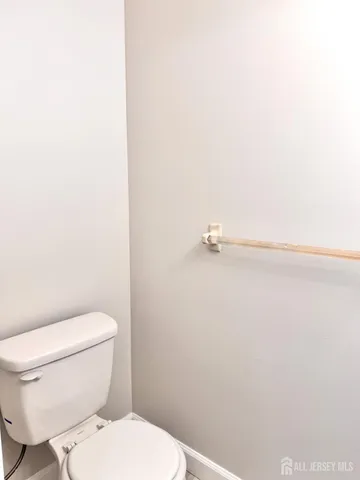 a white toilet sitting next to a shower