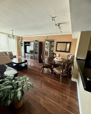a living room with furniture a rug and a flat screen tv