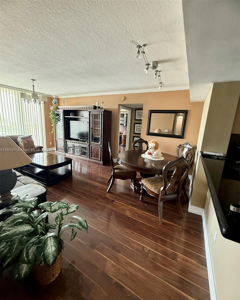2665 Southwest 37th Avenue, Unit 1112 Miami, FL 33133 - Photo 11 of 31 a living room with furniture a rug and a flat screen tv