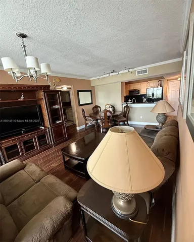 a living room with furniture a flat screen tv and a window