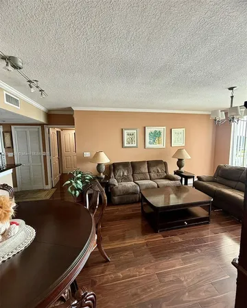 a living room with furniture rug and wooden floor