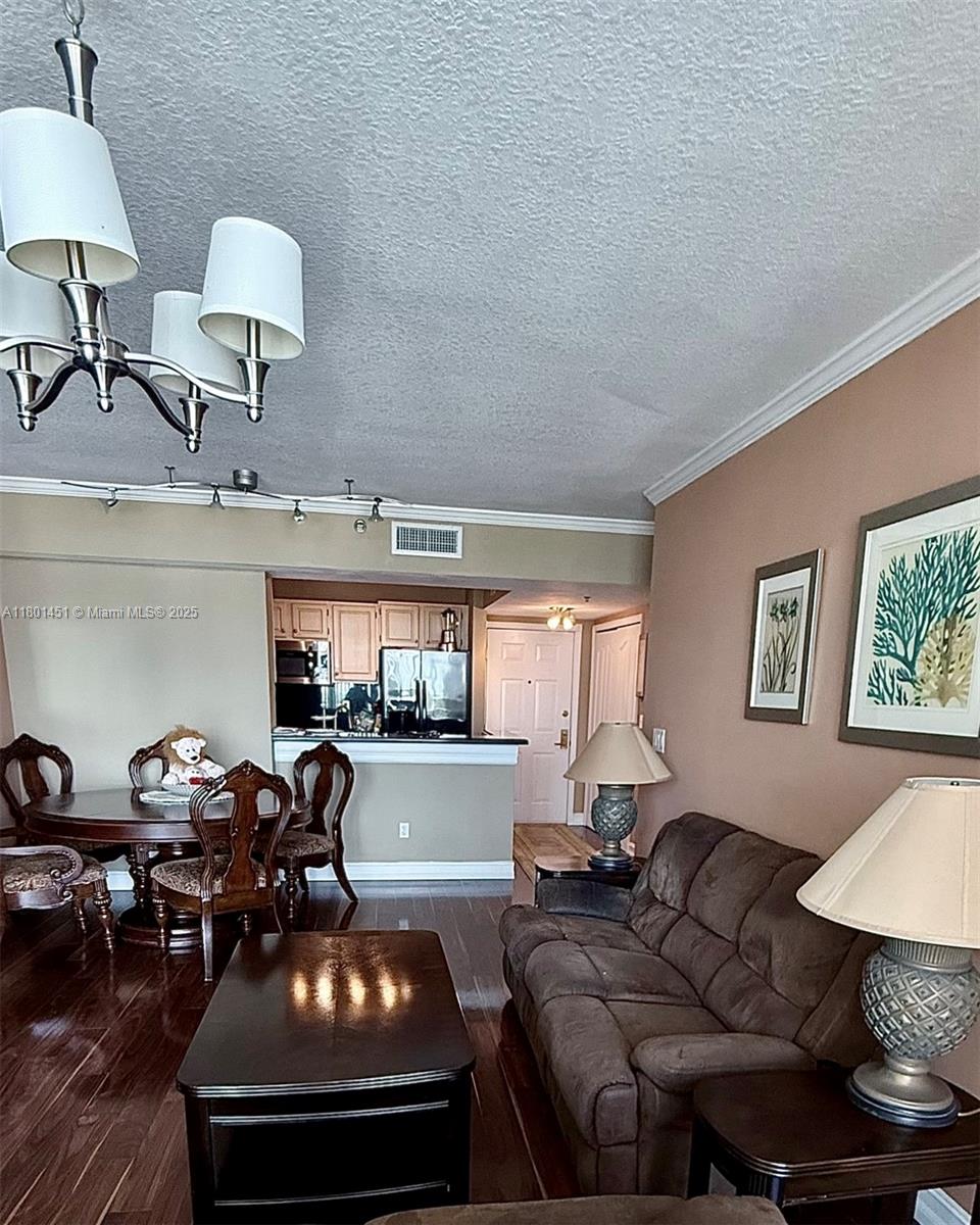2665 Southwest 37th Avenue, Unit 1112 Miami, FL 33133 - Photo 14 of 31 a living room with furniture and a lamp
