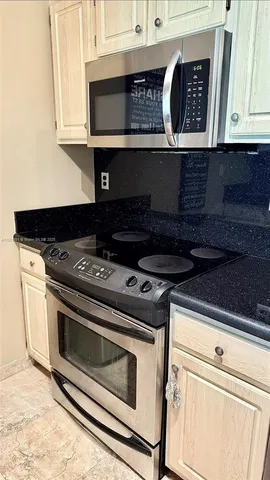 a stove top oven sitting inside of a kitchen