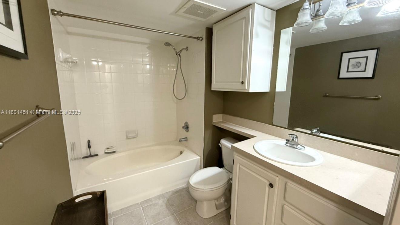 2665 Southwest 37th Avenue, Unit 1112 Miami, FL 33133 - Photo 28 of 31 a bathroom with a sink a toilet and shower