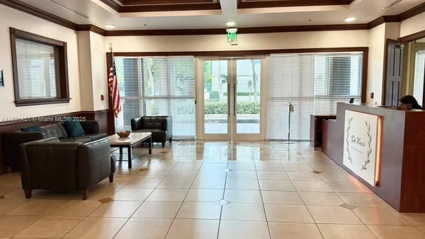 a lobby with furniture and floor to ceiling window