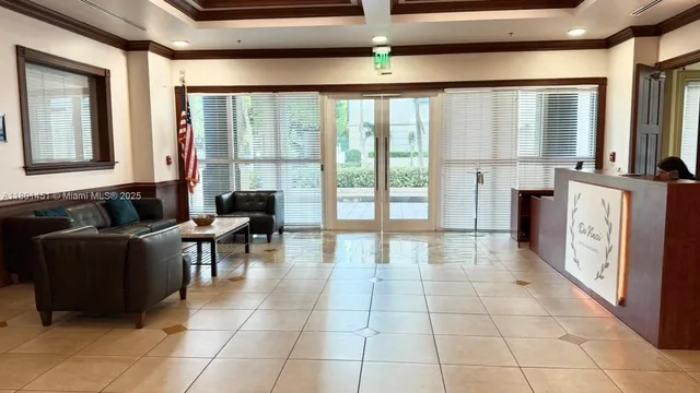a lobby with furniture and floor to ceiling window