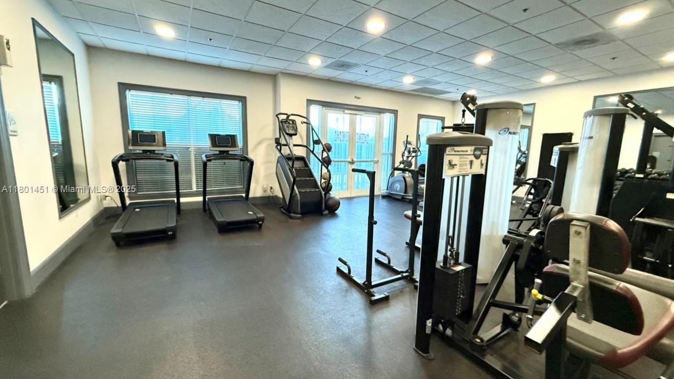 2665 Southwest 37th Avenue, Unit 1112 Miami, FL 33133 - Photo 4 of 31 a view of a room with gym equipment