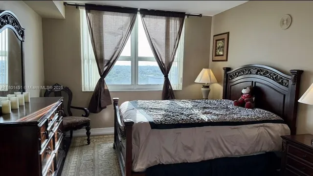 a bedroom with a bed and a large window