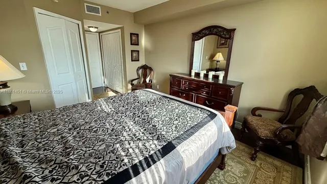 a bedroom with a bed and a mirror