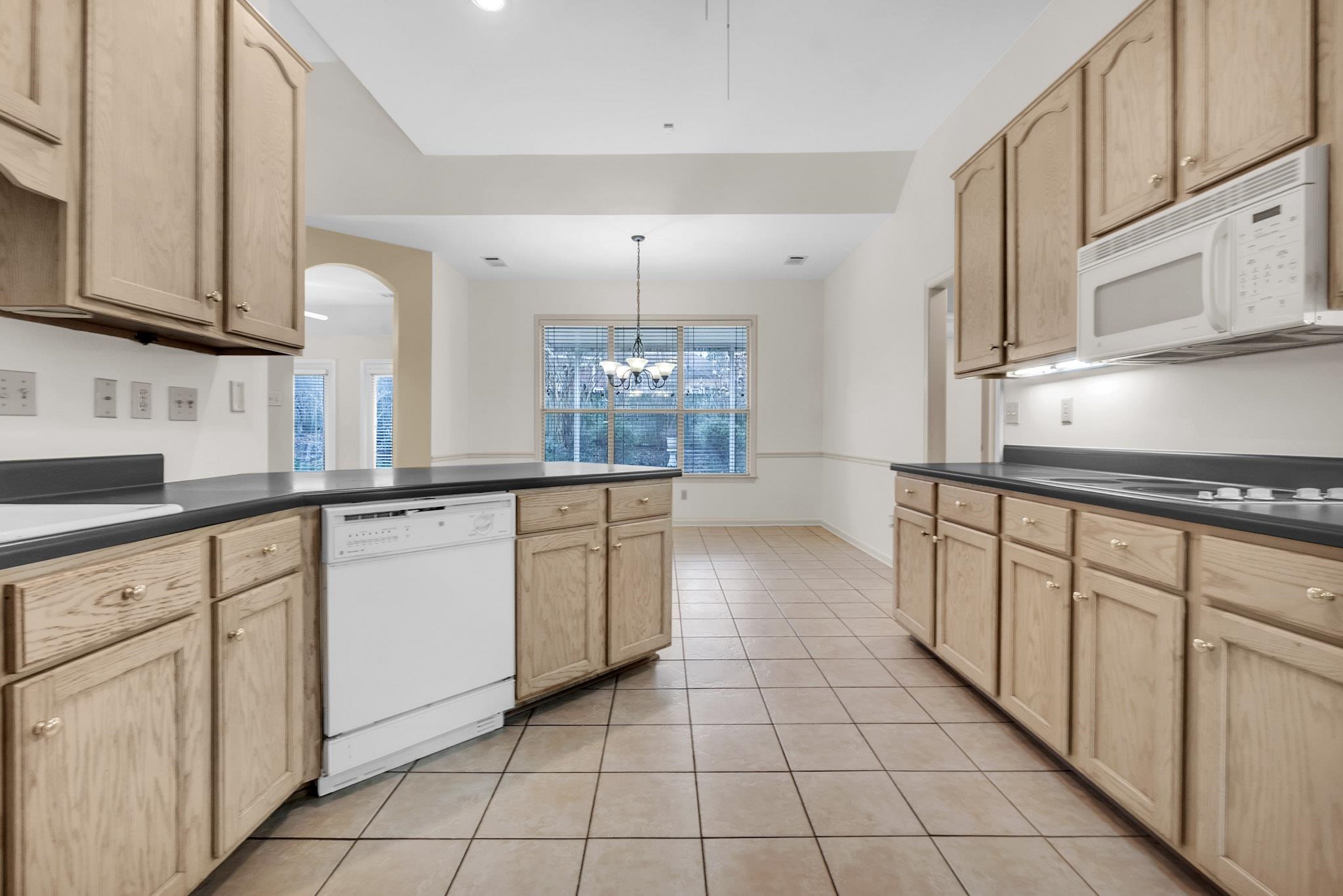 6307 Thistle Point Bartlett, TN 38135 - Photo 16 of 31 a large kitchen with white cabinets