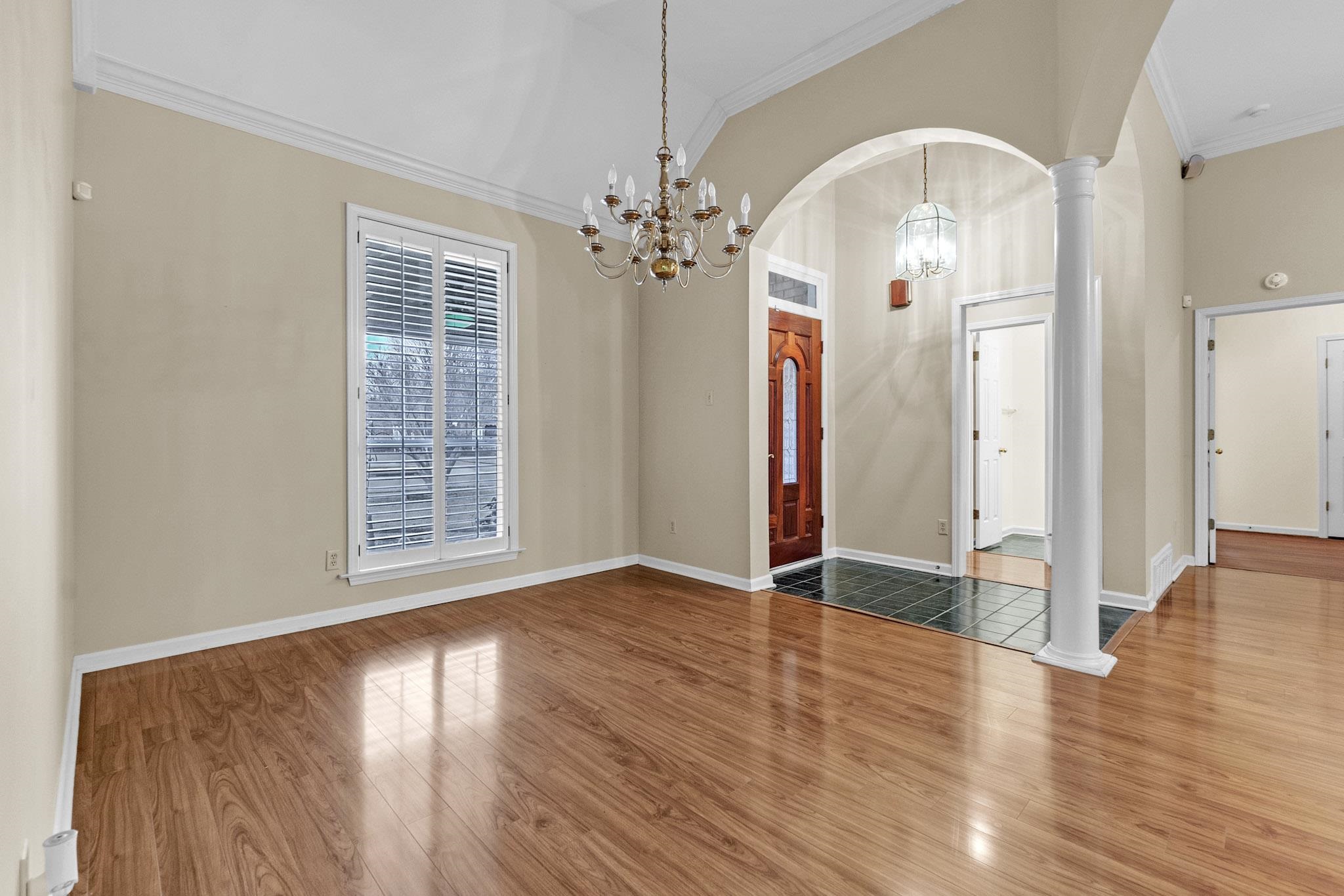 6307 Thistle Point Bartlett, TN 38135 - Photo 18 of 31 an empty room with wooden floor chandelier and windows