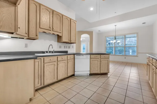 a kitchen with stainless steel appliances granite countertop a sink and cabinets