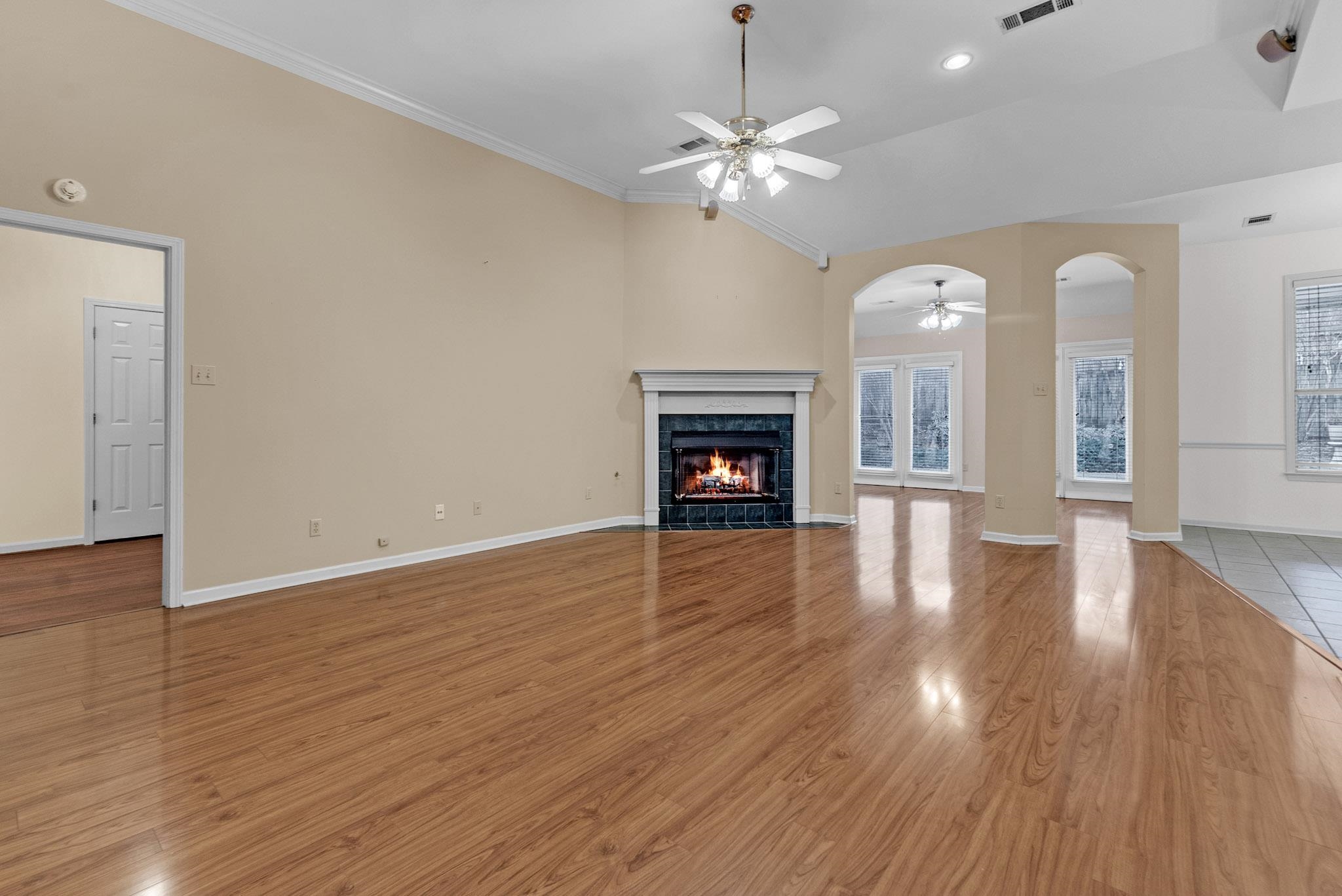 6307 Thistle Point Bartlett, TN 38135 - Photo 20 of 31 a view of an empty room with wooden floor fireplace and a window