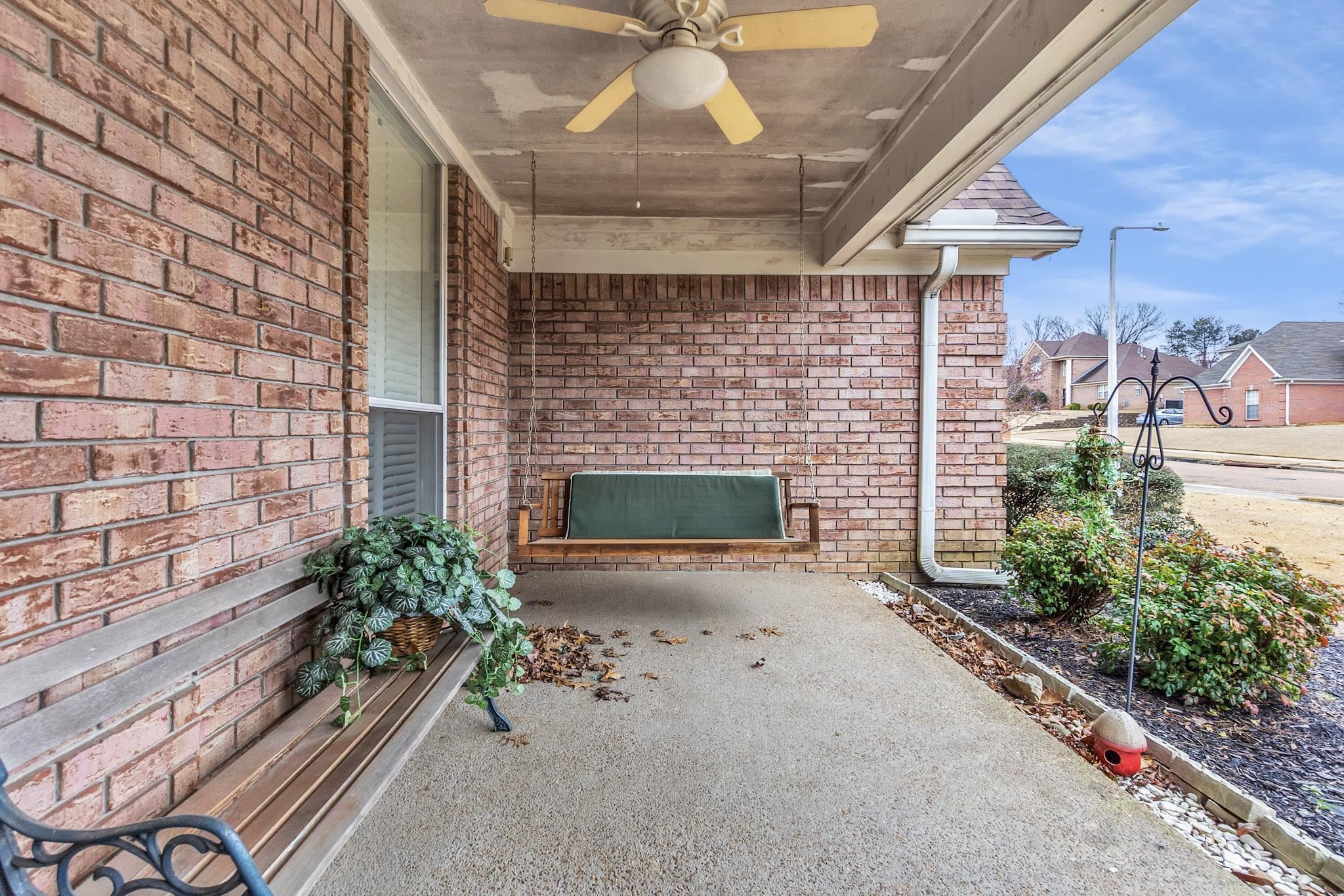 6307 Thistle Point Bartlett, TN 38135 - Photo 22 of 31 a stone house with potted plants in front of it