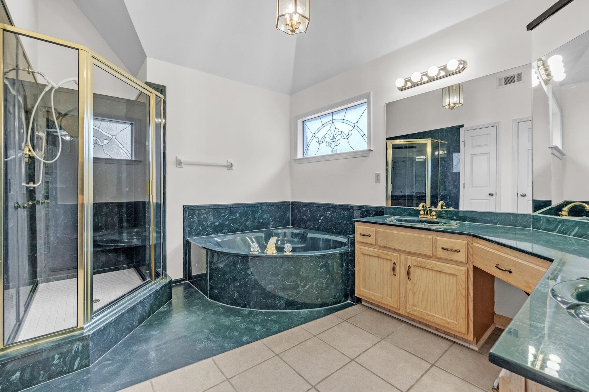 6307 Thistle Point Bartlett, TN 38135 - Photo 30 of 31 a spacious bathroom with a granite countertop sink a mirror and a shower