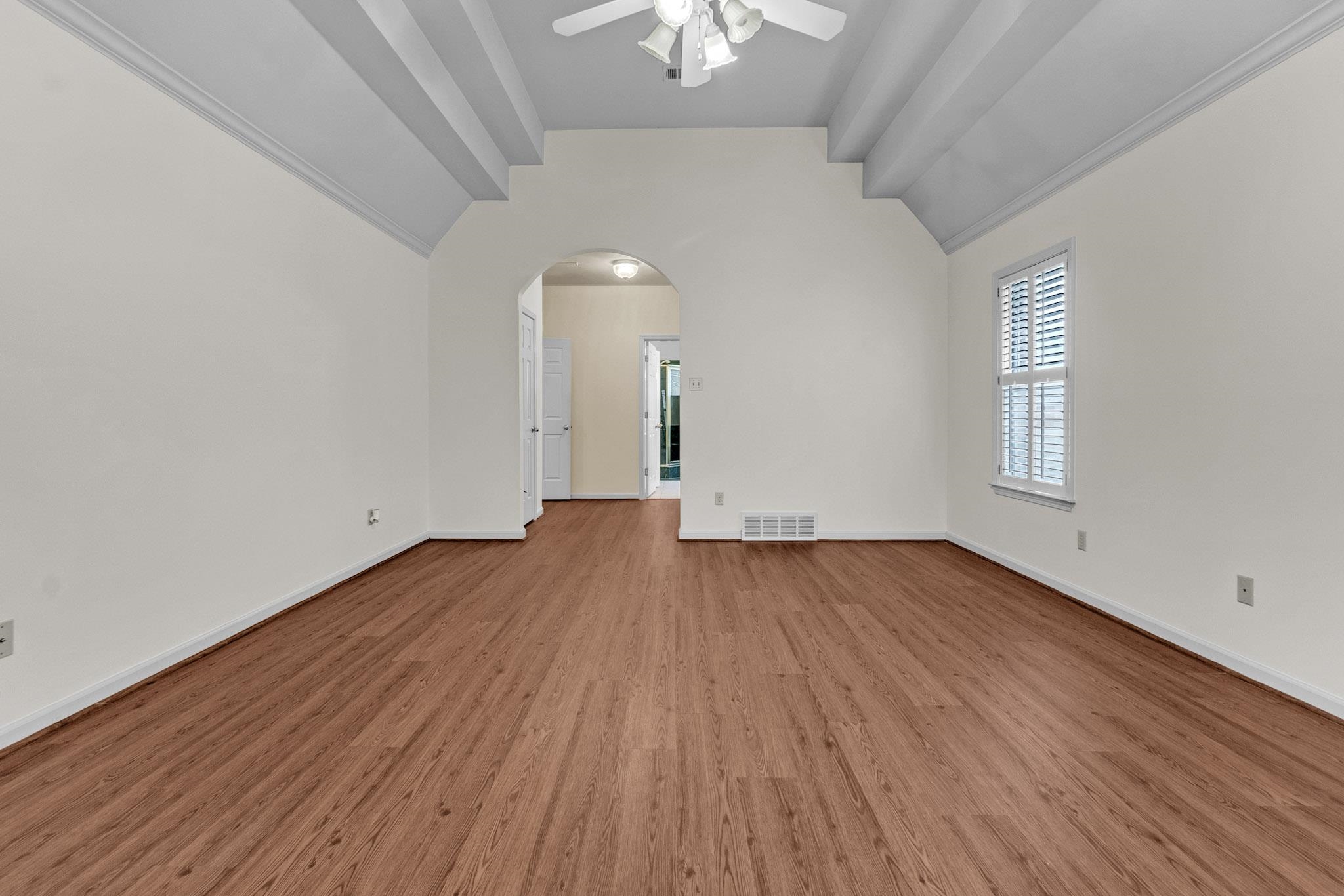 6307 Thistle Point Bartlett, TN 38135 - Photo 6 of 31 an empty room with wooden floor chandelier fan and windows