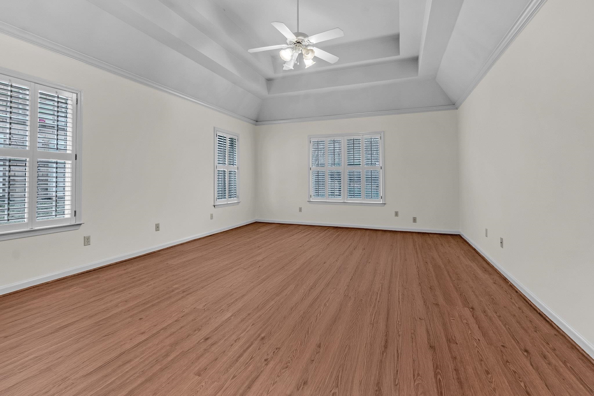 6307 Thistle Point Bartlett, TN 38135 - Photo 7 of 31 an empty room with wooden floor chandelier fan and windows