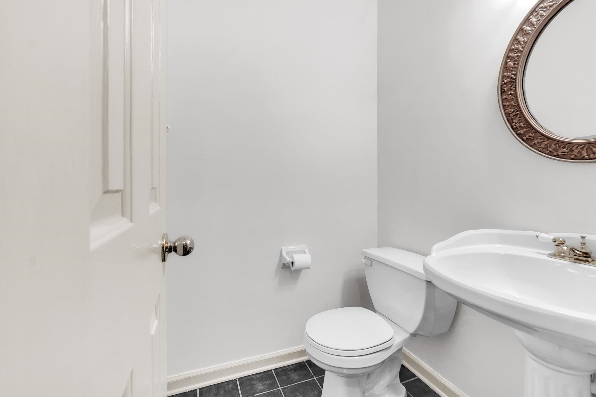 6307 Thistle Point Bartlett, TN 38135 - Photo 9 of 31 a white toilet sitting next to a bathroom sink