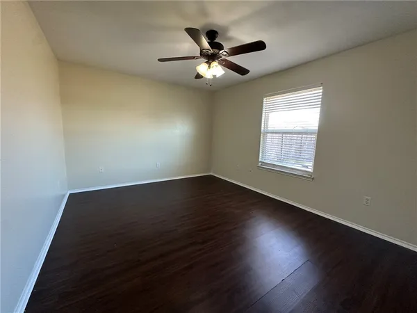 a view of wooden floor and windows in a room