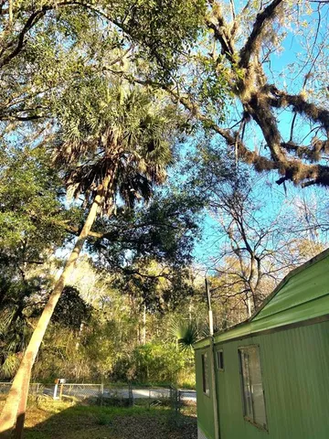 a backyard of a house with lots of tree