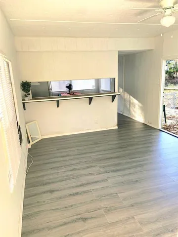 a view of kitchen and wooden floor