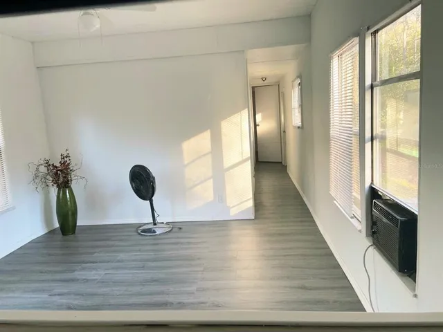 a view of a hallway view with wooden floor and staircase