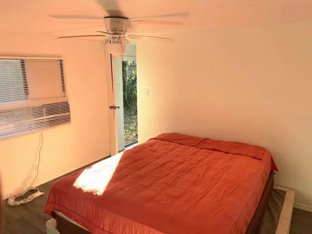 a bedroom with a bed and a window
