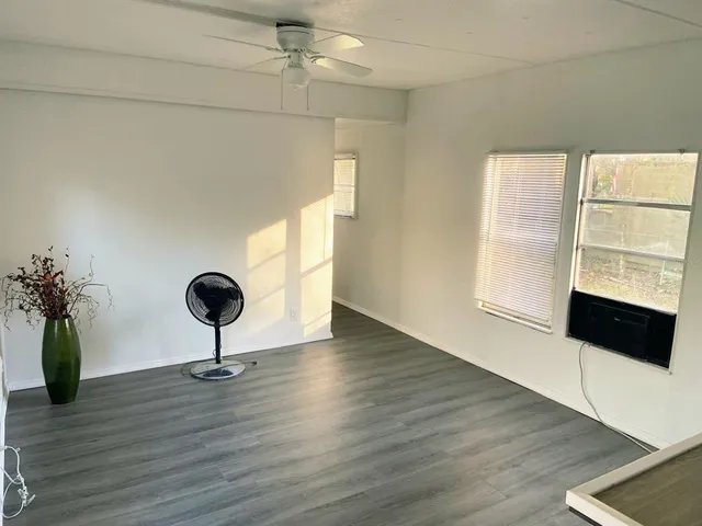 a view of room with a window and wooden floor