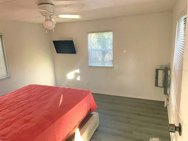 a bedroom with a bed and a flat screen tv