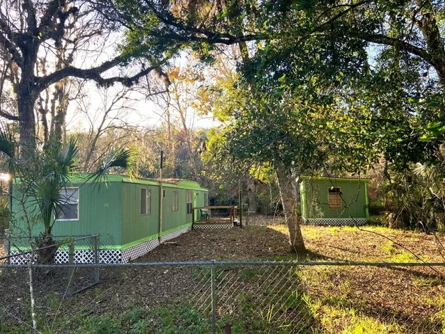a view of a house with a backyard