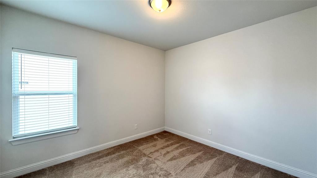 601 C-Bar Ranch Trail, Unit 27 Cedar Park, TX 78613 - Photo 14 of 29 Neutral wall tones complement plush patterned carpeting