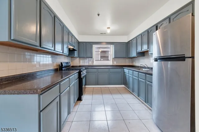 a kitchen with stainless steel appliances granite countertop a refrigerator sink and cabinets