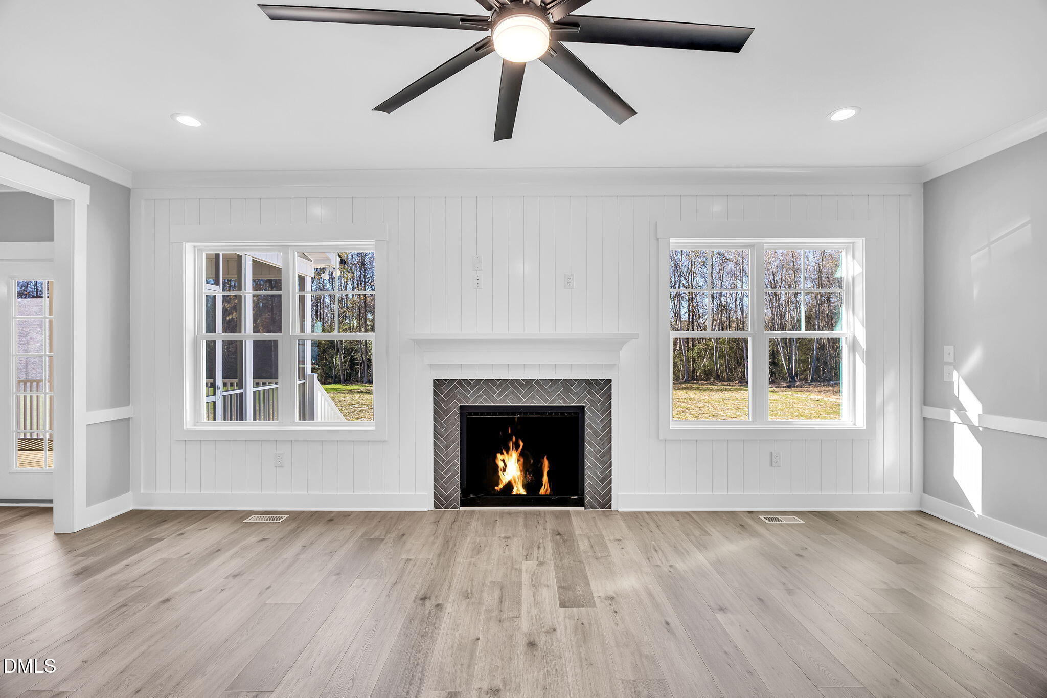 250 Freedom Ridge Drive Smithfield, NC 27577 - Photo 12 of 32 a view of an empty room with wooden floor fireplace and a window