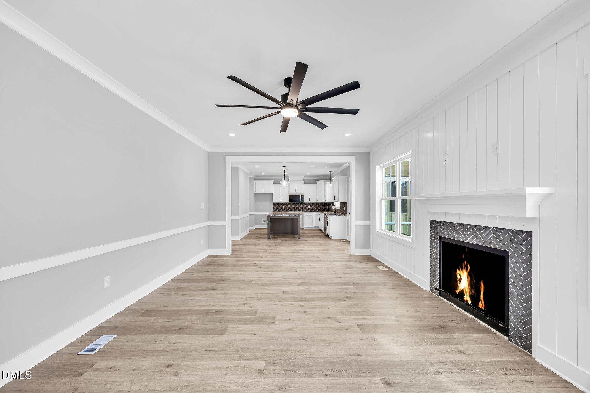 250 Freedom Ridge Drive Smithfield, NC 27577 - Photo 13 of 32 a view of a livingroom with a fireplace a ceiling fan and a kitchen