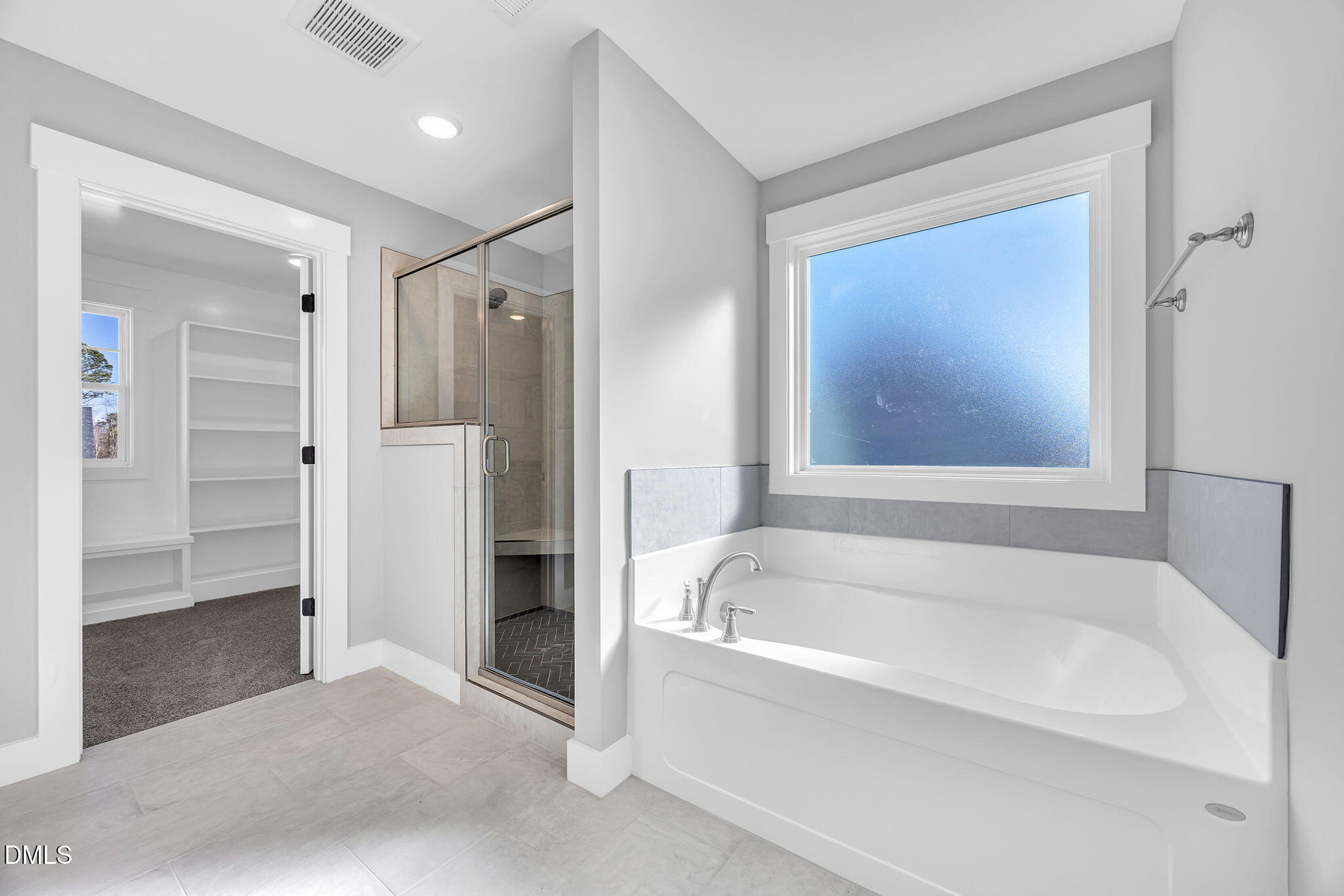 250 Freedom Ridge Drive Smithfield, NC 27577 - Photo 23 of 32 a bathroom with a bathtub and a shower