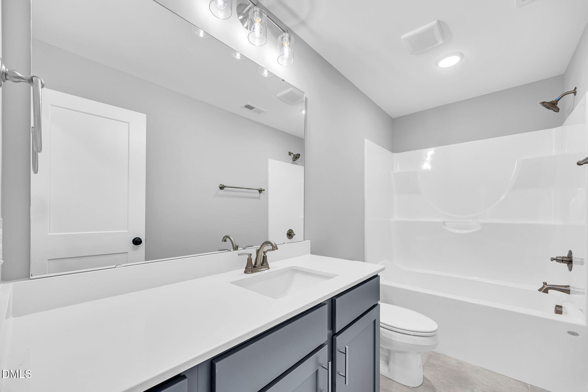 250 Freedom Ridge Drive Smithfield, NC 27577 - Photo 25 of 32 a bathroom with a sink a toilet a mirror and bathtub