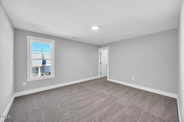 a view of an empty room with a ceiling fan
