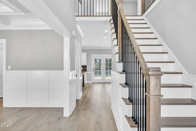 a view of staircase with railing and white walls
