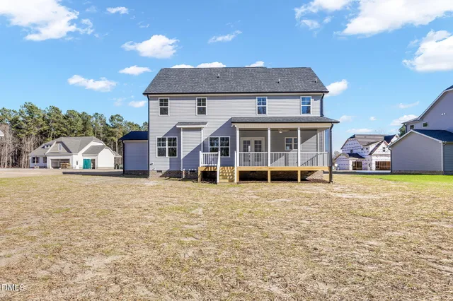 a front view of a house with a yard and seating space