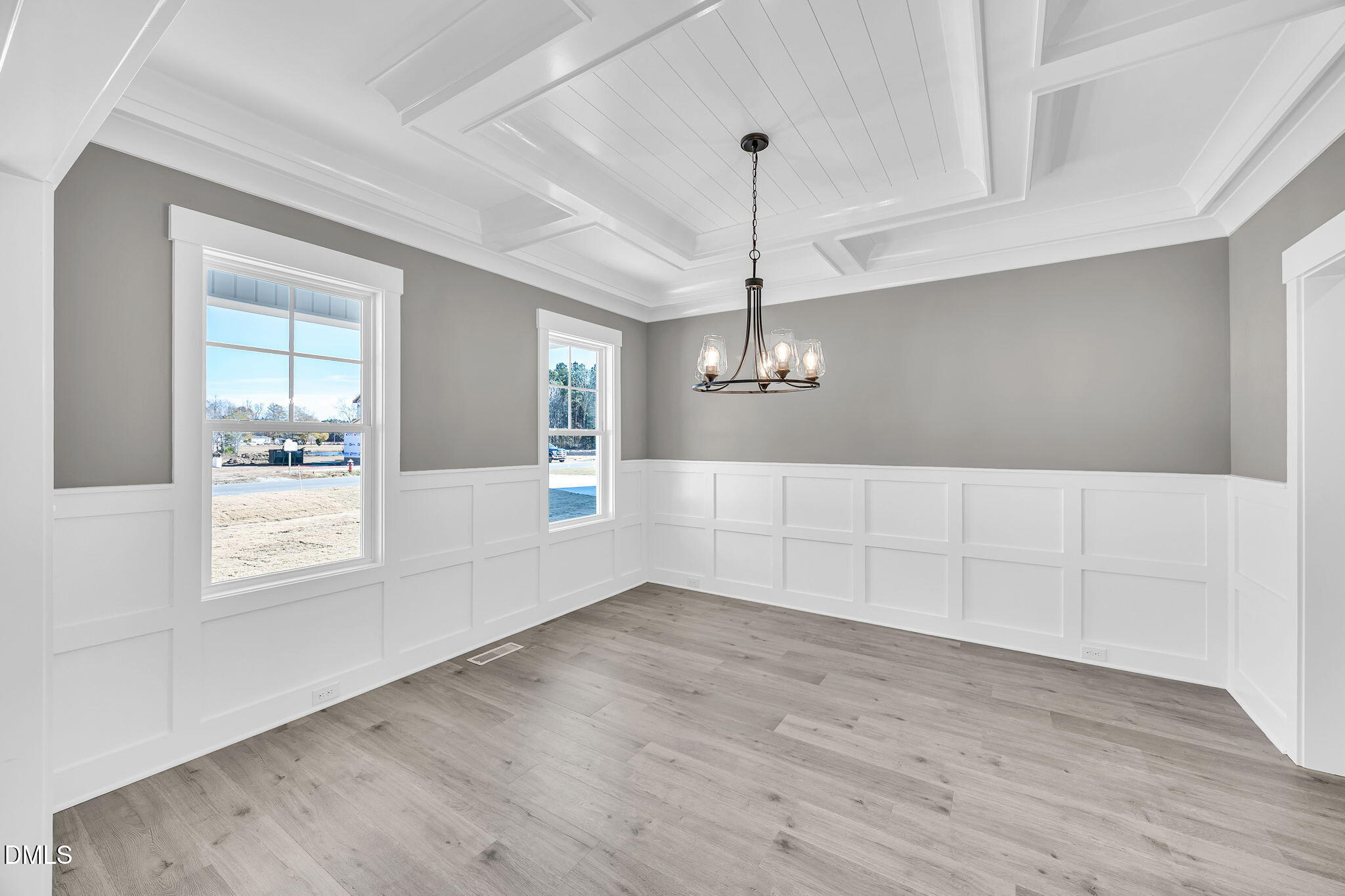 250 Freedom Ridge Drive Smithfield, NC 27577 - Photo 5 of 32 an empty room with wooden floor cabinet and windows
