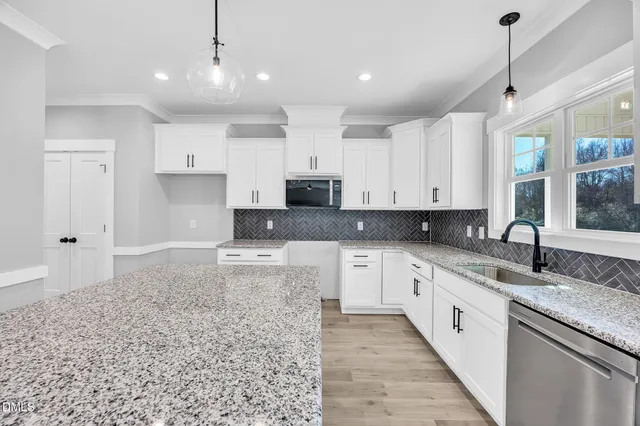 a kitchen with kitchen island a sink and wooden floor