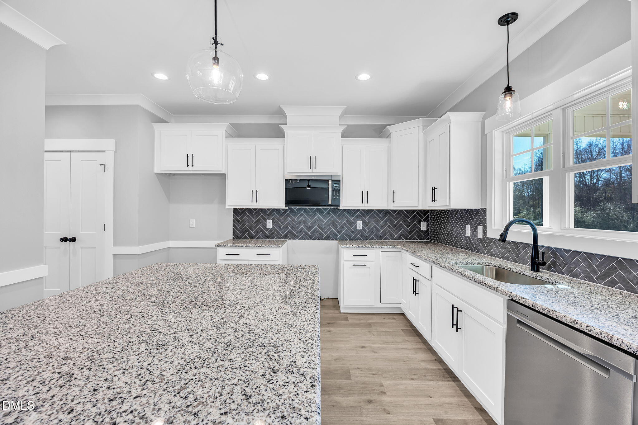 250 Freedom Ridge Drive Smithfield, NC 27577 - Photo 9 of 32 a large kitchen with granite countertop a sink and white cabinets