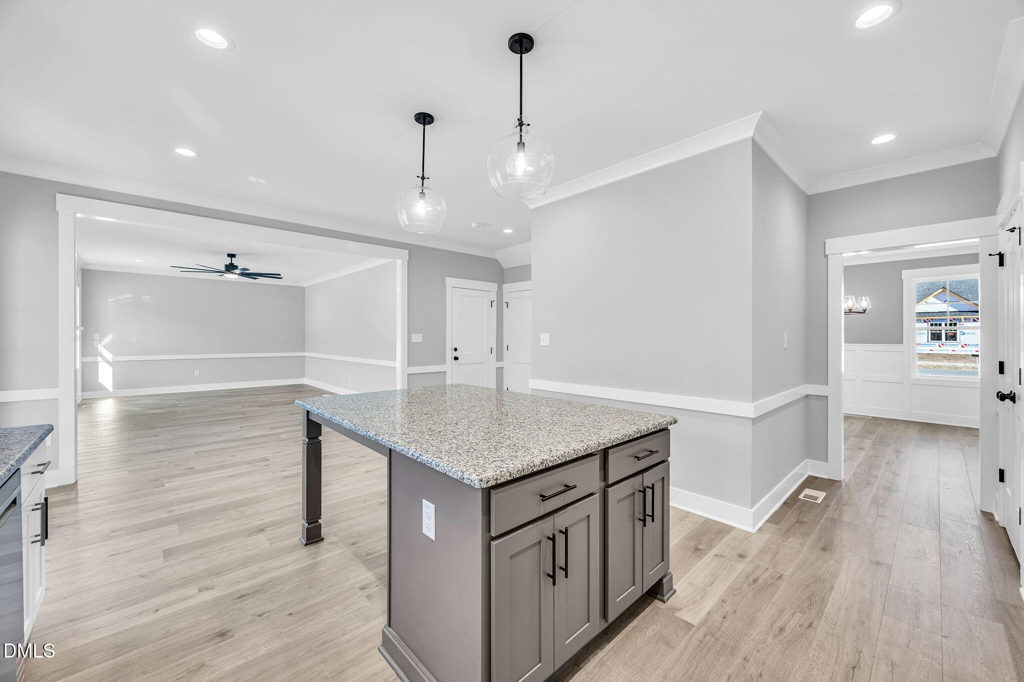 250 Freedom Ridge Drive Smithfield, NC 27577 - Photo 10 of 32 a kitchen with kitchen island a sink and wooden floor