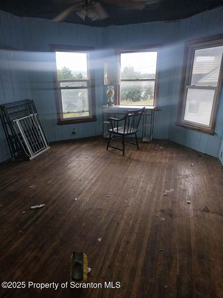 507 Delaware Street Forest City, PA 18421 - Photo 15 of 24 an empty room with wooden floor and windows