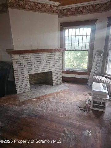 a view of an empty room with a fireplace