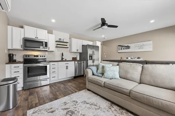 a view of kitchen with microwave stove top oven and cabinets