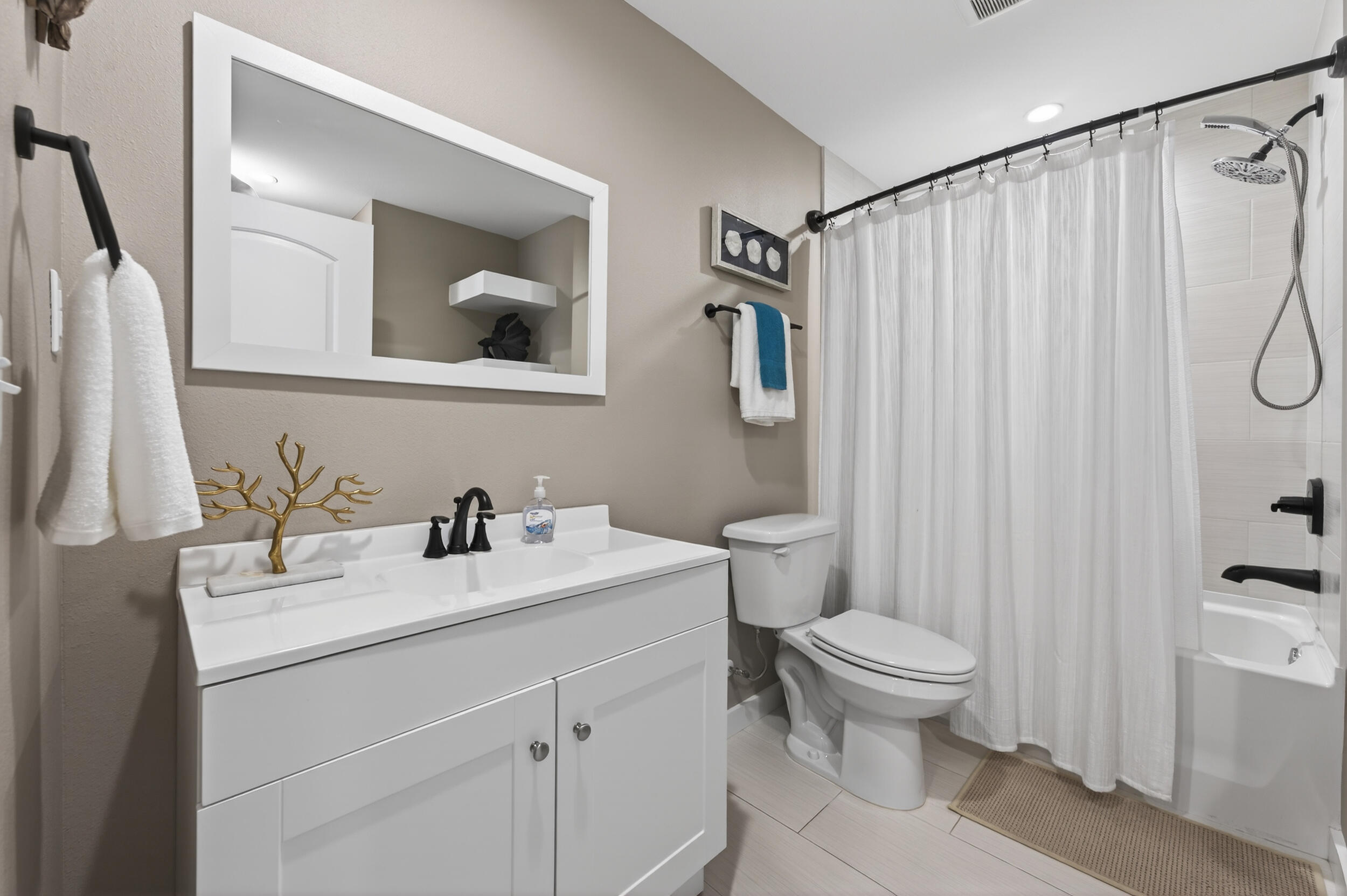 60 McDaniels Fishcamp Road, Unit A Freeport, FL 32439 - Photo 14 of 67 a bathroom with a sink vanity mirror and toilet